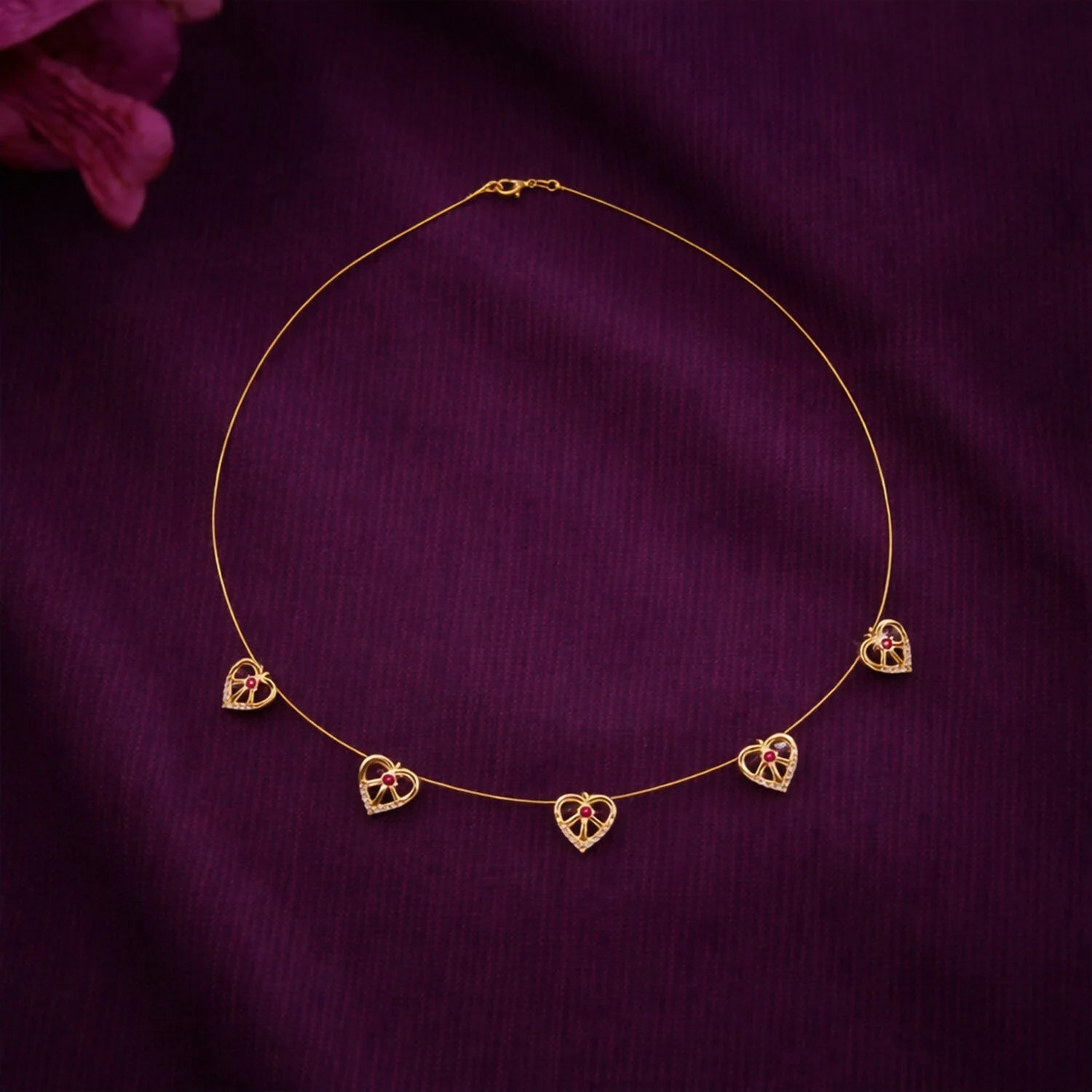 Elegant Gold-Tone Multi-Heart Charm Necklace with Red Crystals